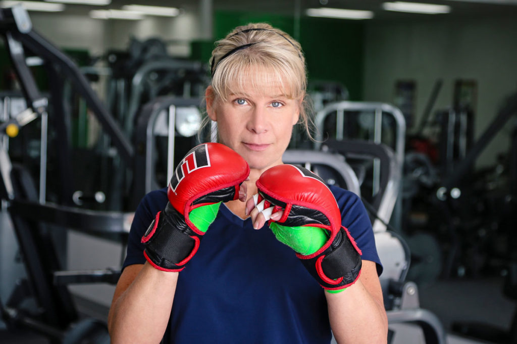 Michelle Sukow wears boxing gloves and confidently looks into the camera.